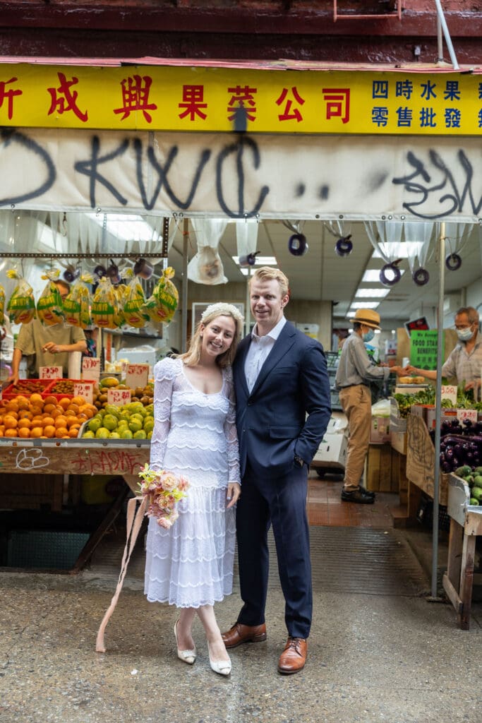 Newlyweds take wedding portraits along Mott St in Chinatown NYC.