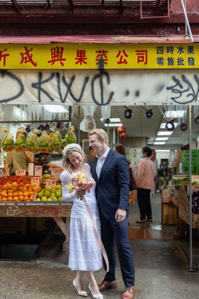 Newlyweds take wedding portraits along Mott St in Chinatown NYC.