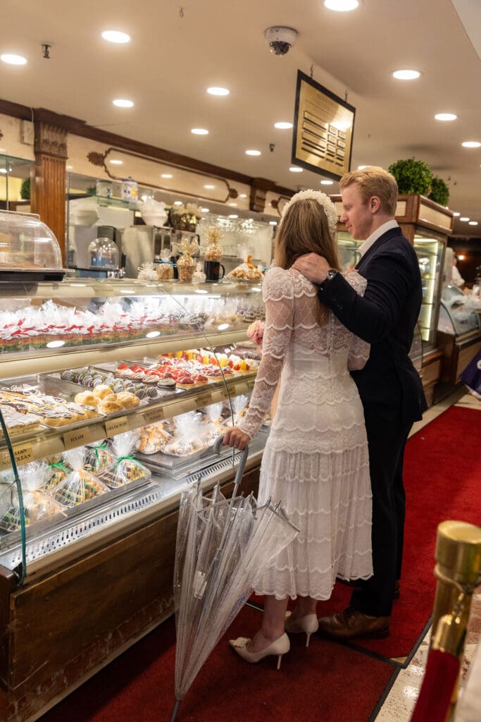 Newlyweds shop for pastries at Ferrara's in NYC's Little Italy.