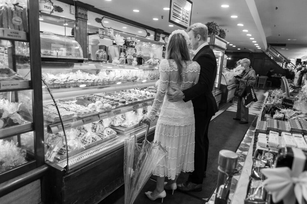 Newlyweds shop for pastries at Ferrara's in NYC's Little Italy.