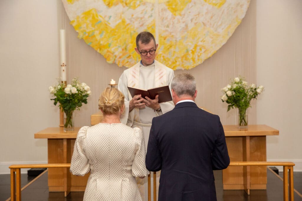 NYC Elopement at the Norwegian Seamen's Church. Bride and Groom pray during ceremony.