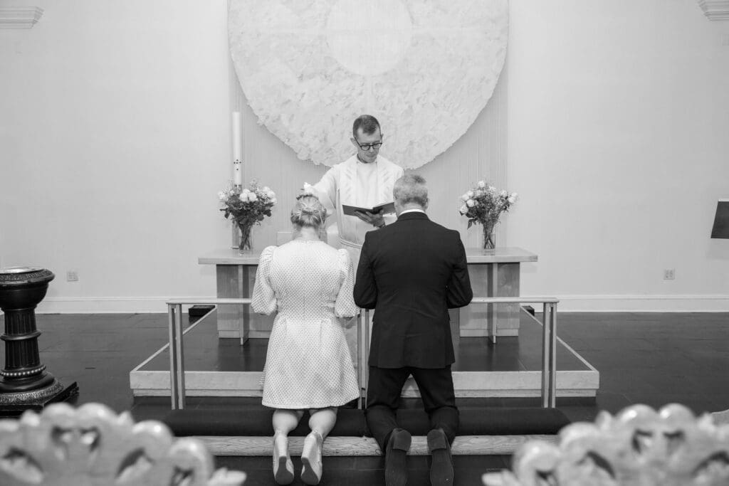NYC Elopement at the Norwegian Seamen's Church. Bride and Groom pray during ceremony.