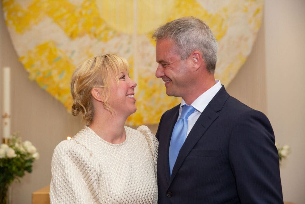 NYC Elopement at the Norwegian Seamen's Church. Bride and Groom smile at each other after ceremony.