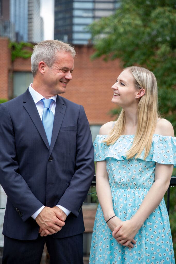 NYC Elopement at the Norwegian Seamen's Church. Groom poses with his children on rooftop after ceremony.