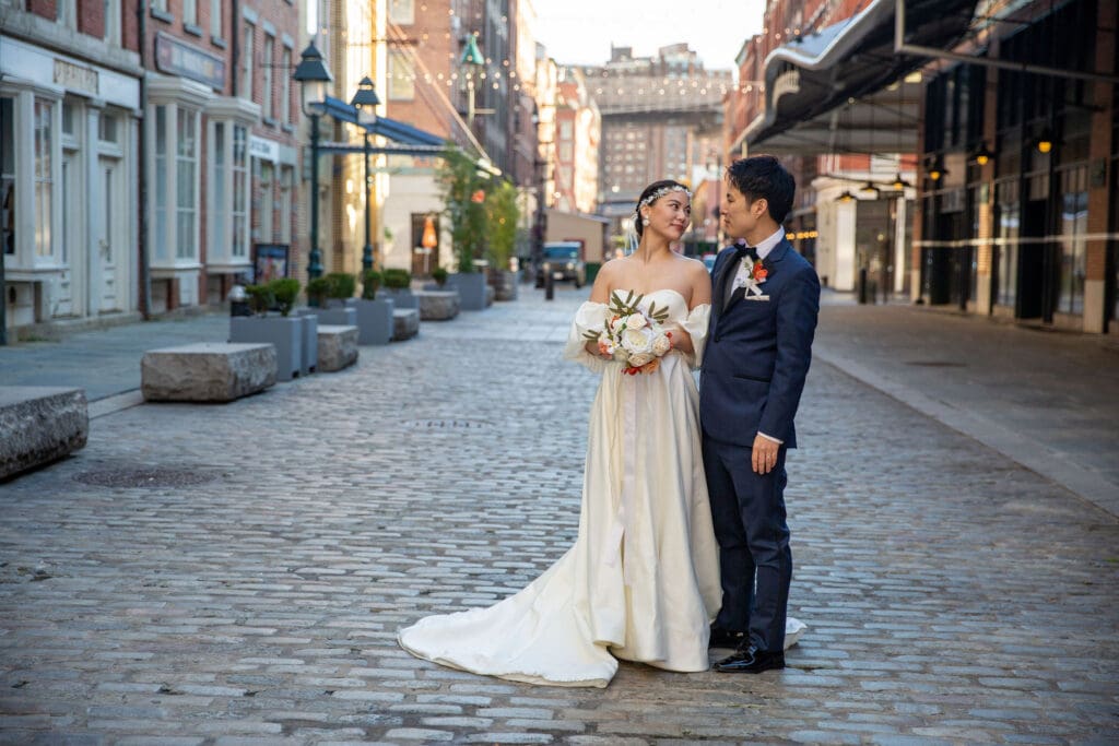 Newlyweds pose for wedding portraits in South Street Seaport in NYC.