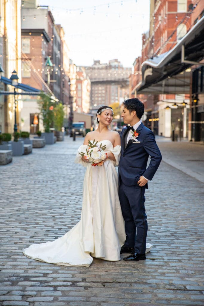 Newlyweds pose for wedding portraits in South Street Seaport in NYC.