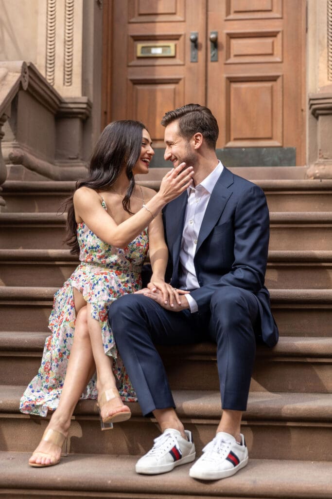 Engaged couple walk down the streets of the Upper West Side in NYC.