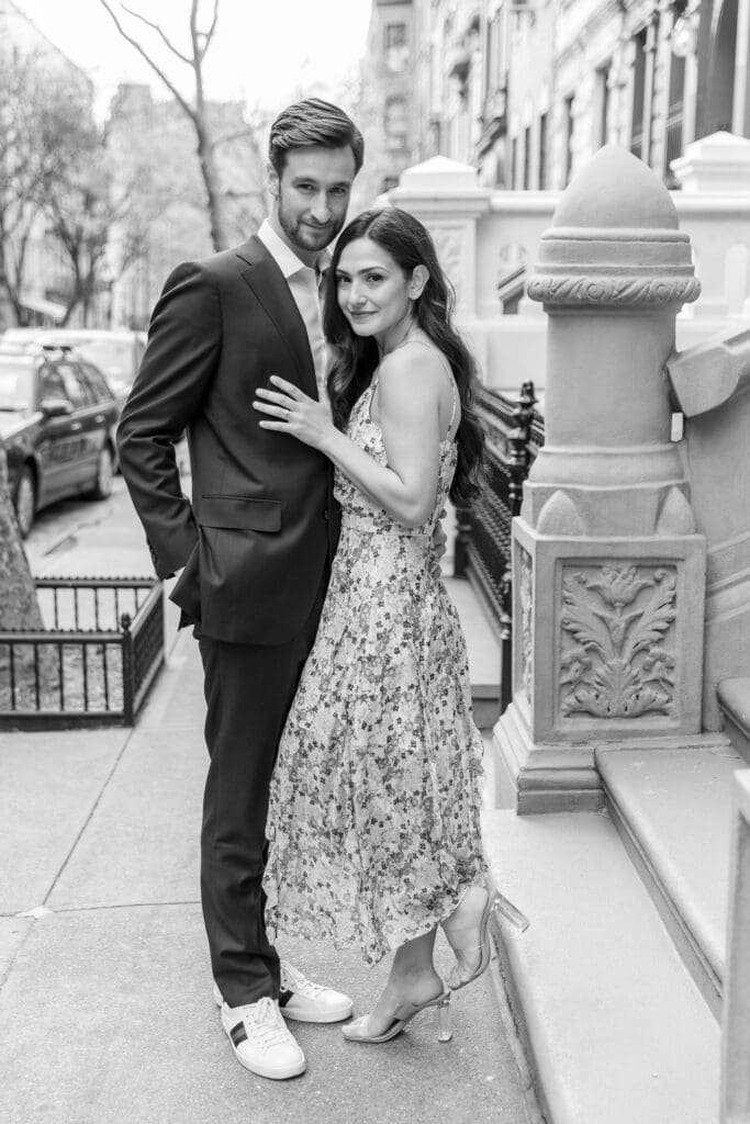 Engaged couple walk down the streets of the Upper West Side in NYC.