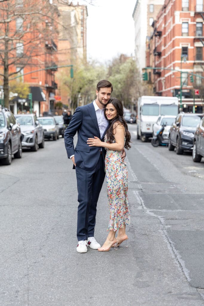 Engaged couple walk down the streets of the Upper West Side in NYC.