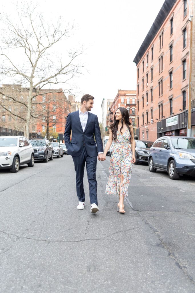 Engaged couple walk down the streets of the Upper West Side in NYC.