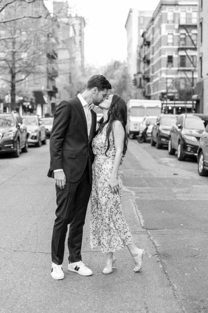 Engaged couple kiss on the streets of the Upper West Side in NYC.