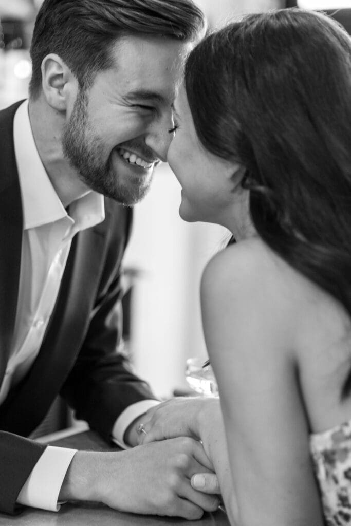 Engaged couple smile at the bar at Vin Sur Vingt on Manhattan's Upper West Side.