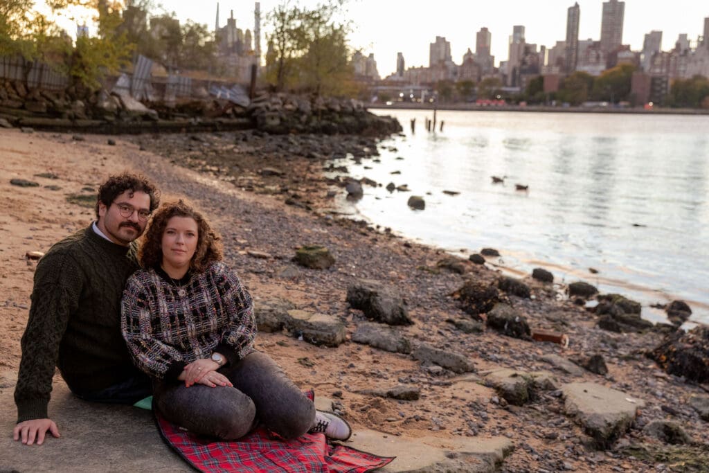 Engaged couple pose at sunset at Hallett's Cove in Astoria, Queens for their fall engagement session.