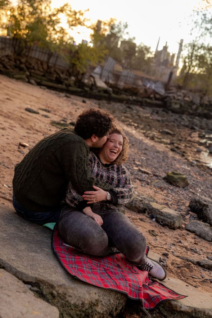 Engaged couple pose at sunset at Hallett's Cove in Astoria, Queens for their fall engagement session.