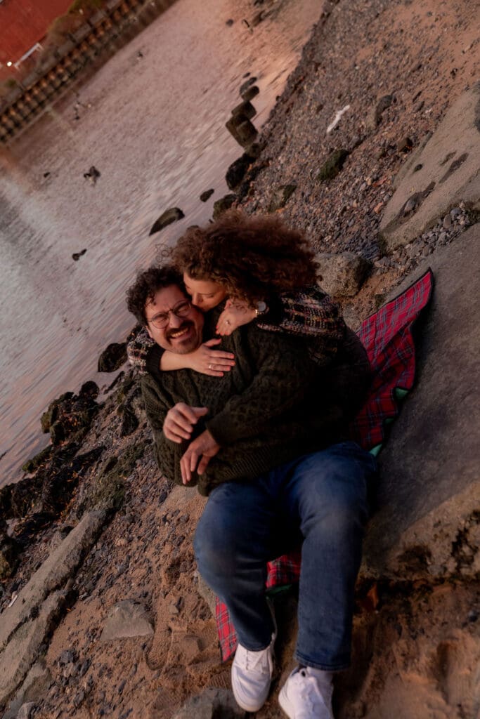 Engaged couple pose at sunset at Hallett's Cove in Astoria, Queens for their fall engagement session.
