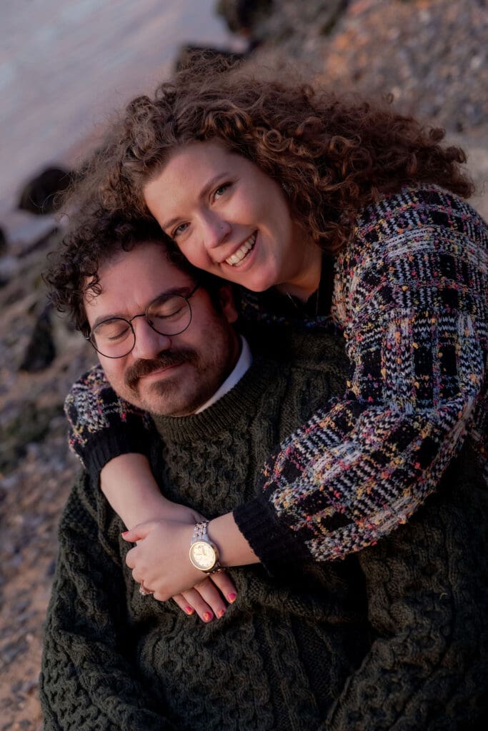 Engaged couple pose at sunset at Hallett's Cove in Astoria, Queens for their fall engagement session.