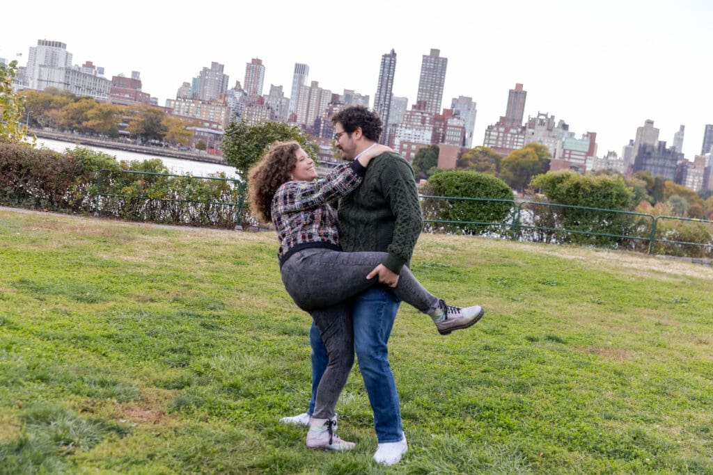 Engaged couple dance in Socrates Sculpture Park in Astoria, Queens for their fall engagement session.