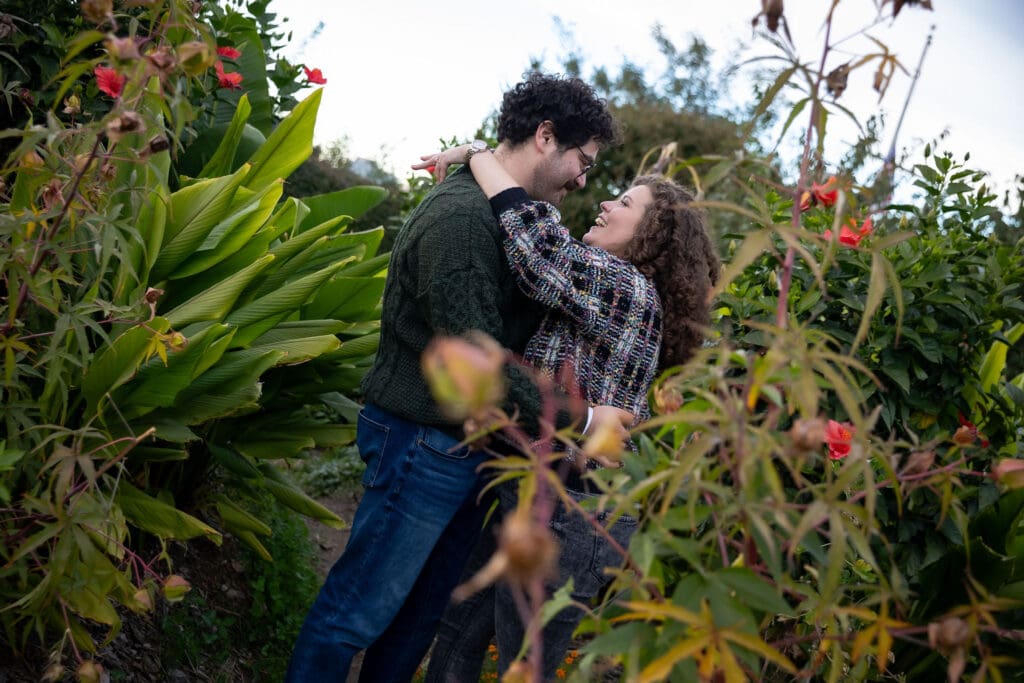 Engaged couple embracing at Socrates Sculpture Park in Astoria, Queens for their fall engagement session.