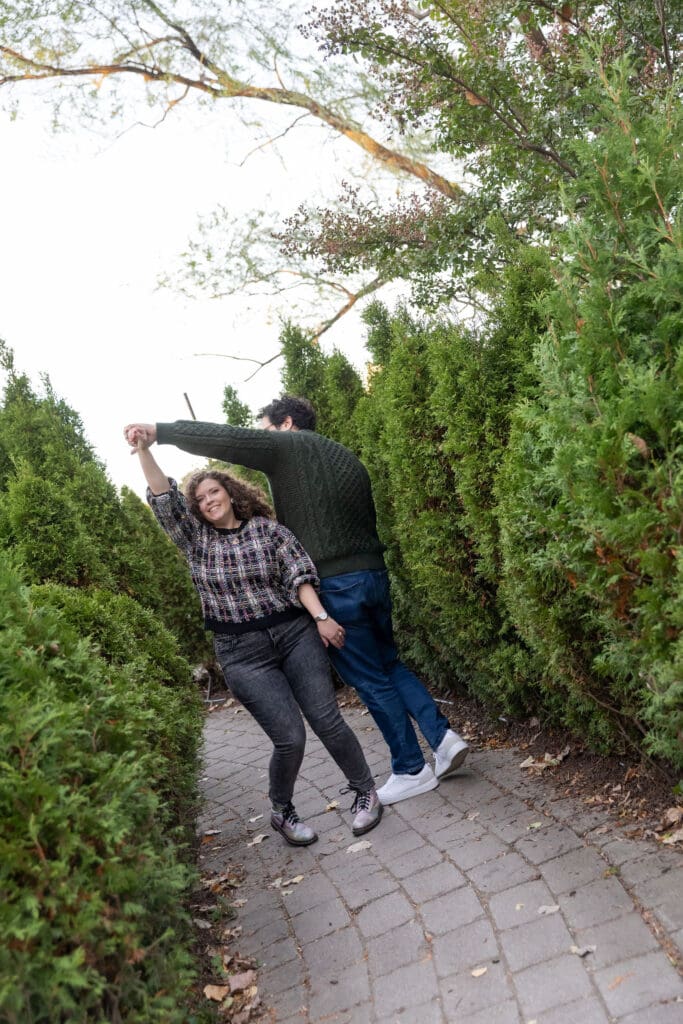 Engaged couple dance at Socrates Sculpture Park in Astoria, Queens for their fall engagement session.